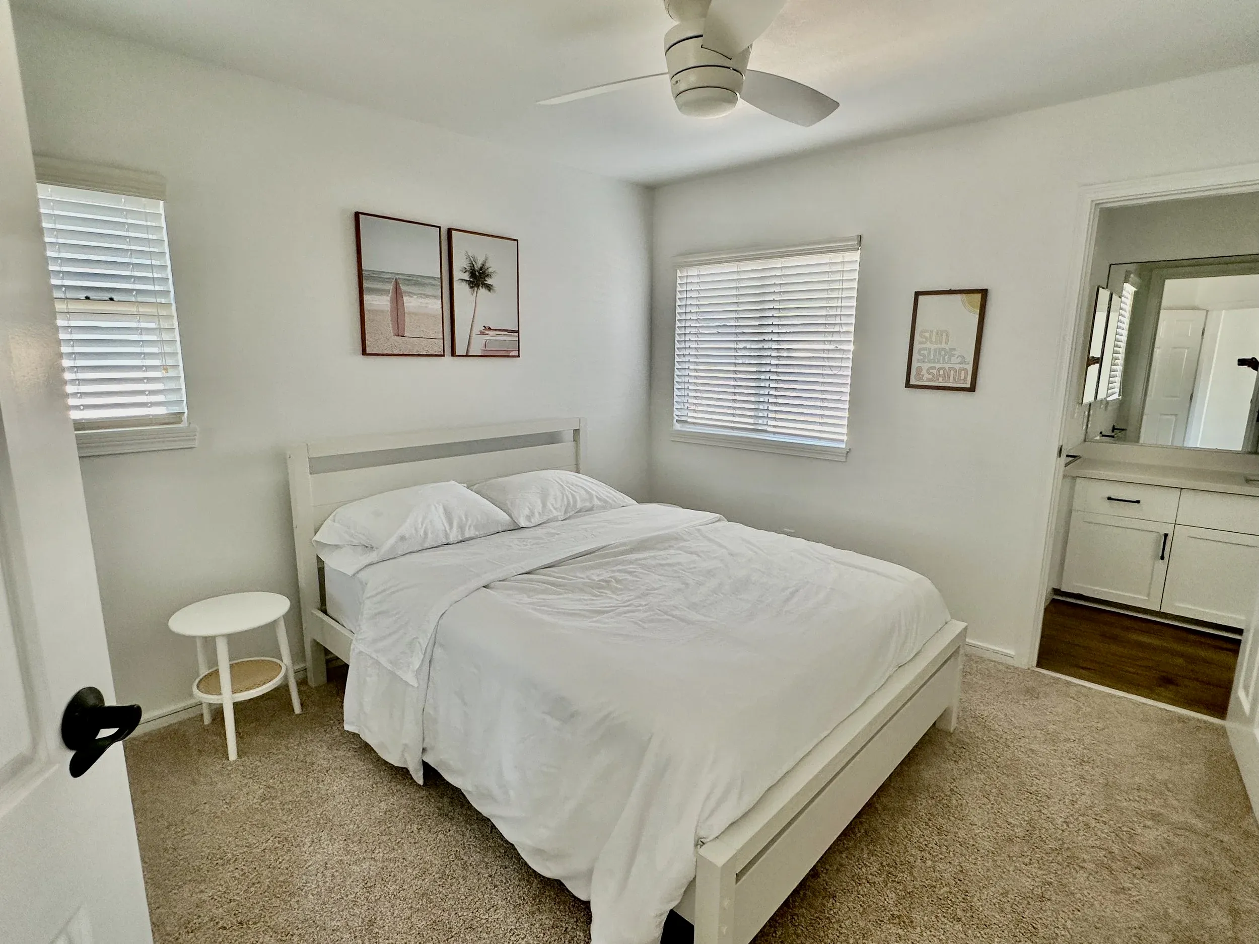 Guest bedroom with queen bed and window