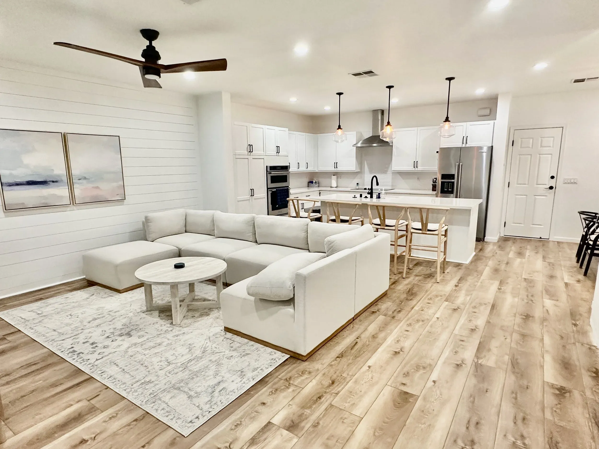 Open great room with kitchen, dining bar, and living area